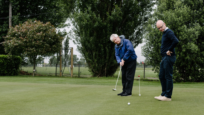 Richard Thaler, left, instructs Jonathan Derbyshire in the unexpectedly complicated pursuit of putting
