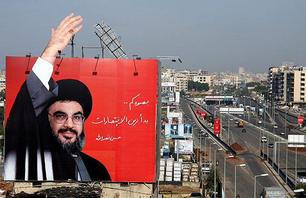 Sayyed Hassan Nasrallah, leader of Hizbollah, hails followers from a hoarding in Beirut