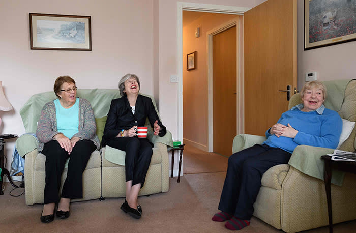 British Prime Minister Theresa May (C) chats with residents Val Lay (L) and Rita Bowden during a visit to a housing estate on November 16, 2017 in London, England. British Prime Minister May has pledged to take personal charge of Government plans to address the current housing problem. / AFP PHOTO / POOL / Leon NealLEON NEAL/AFP/Getty Images