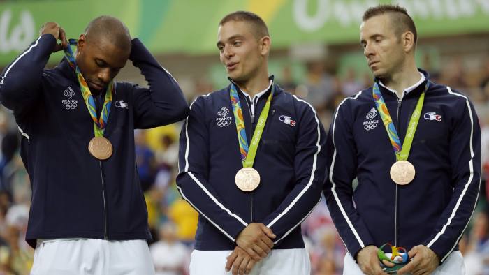 CORRECTS SILVER MEDALISTS TO BRONZE MEDALISTS - French bronze medalists, from left, Gregory Bauge, Michael D'Almeida and Francois Pervis stand on the podium of the men's team sprint finals at the Rio Olympic Velodrome during the 2016 Summer Olympics in Rio de Janeiro, Brazil, Thursday, Aug. 11, 2016. (AP Photo/Patrick Semansky)