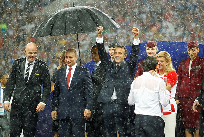 Soccer Football - World Cup - Final - France v Croatia - Luzhniki Stadium, Moscow, Russia - July 15, 2018 President of Croatia Kolinda Grabar-Kitarovic consoles Croatia coach Zlatko Dalic as FIFA president Gianni Infantino, President of Russia Vladimir Putin and President of France Emmanuel Macron look on during the presentation. Kai Pfaffenbach: &quot;Usually a football World Cup is all about the action, goals and emotions on the pitch. This World Cup's final had a lot of that too, but despite the 4-2 result my favourite picture is this. As soon as the victory ceremony started, a heavy downpour began. A helper had an umbrella for Russia President Vladimir Putin quickly on hand, while his counterparts from France and Croatia enjoyed a little shower along with FIFA President Gianni Infantino. France President Emmanuel Macron didn't seem to care and enjoyed himself - and his team's victory - while Croatia President Kolinda Grabar-Kitarovic comforted her team's coach.&quot; REUTERS/Kai Pfaffenbach/File Photo SEARCH &quot;PHOTOGRAPHERS BEST&quot; FOR THIS STORY. SEARCH &quot;WIDER IMAGE&quot; FOR ALL STORIES. TPX IMAGES OF THE DAY.