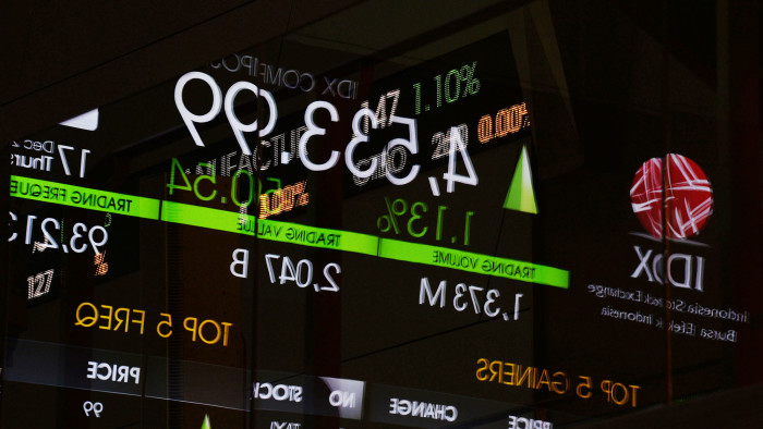 An electronic board displaying the Jakarta Composite Index figure is reflected on a glass window inside the Indonesia Stock Exchange (IDX) in Jakarta, Indonesia, on Thursday, Dec. 17, 2015. Stocks and the dollar climbed, while Treasuries clawed back some gains as the first U.S. interest-rate increase in almost a decade was welcomed across Asian markets. Photographer: Dimas Ardian/Bloomberg