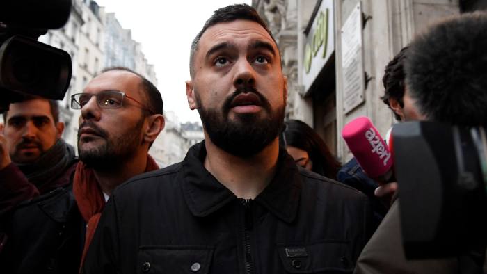 Eric Drouet (C), a leader of the "Yellow Vests" (Gilets jaunes) anti-government protests, walks with his lawyer Kheops Lara (L), and surrounded by members of the press after leaving the police station of Paris's 2nd arrondissement on January 3, 2019, at the end of his custody after being detained the night before by police during a yellow vests demonstration. - One of the leaders of the "yellow vest" demonstrations in France was detained by police in Paris, signalling a harder line from the government that sparked a wave of criticism from opponents on January 3. Eric Drouet -- who already faces a trial for carrying a weapon at a previous protest -- was arrested late on January 2 for organising an unauthorised protest on the Champs-Elysees avenue. He was released in the afternoon of January 3. (Photo by Bertrand GUAY / AFP) (Photo credit should read BERTRAND GUAY/AFP/Getty Images)