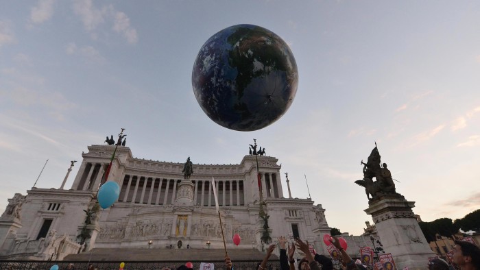 People play with a giant balloon representing Earth at Piazza Venezia during a rally calling for action on climate change on November 29, 2015 in Rome a day before the launch of the COP21 conference in Paris. Some 150 leaders including US President Barack Obama, China’s Xi Jinping, India’s Narendra Modi and Russia’s Vladimir Putin will attend the start of the UN conference Monday, tasked with reaching the first truly universal climate pact. The goal is to limit average global warming to two degrees Celsius (3.6 degrees Fahrenheit), perhaps less, over pre-Industrial Revolution levels by curbing fossil fuel emissions blamed for climate change. AFP PHOTO / TIZIANA FABI / AFP / TIZIANA FABI (Photo credit should read TIZIANA FABI/AFP/Getty Images)