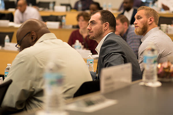 Andrew DePaola, long snapper of the Tampa Bay Buccaneers on the left, and Konrad Reuland, a Baltimore Ravens tight end on the right, in class at the Ross M Business School at the University of 