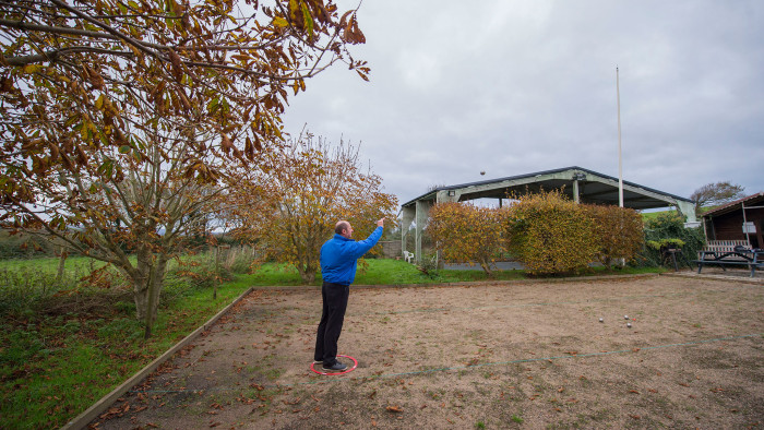 Mike Pegg in throwing position while giving a pétanque lesson