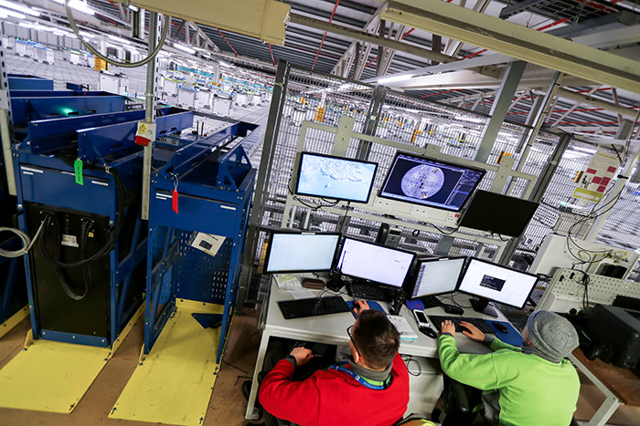 Technicians oversee the operations of the &quot;smart platform&quot; at the Ocado CFC (Customer Fulfilment Centre) in Andover, Britain May 1, 2018. Picture taken May 1, 2018. REUTERS/Peter Nicholls - RC15C3BD7090