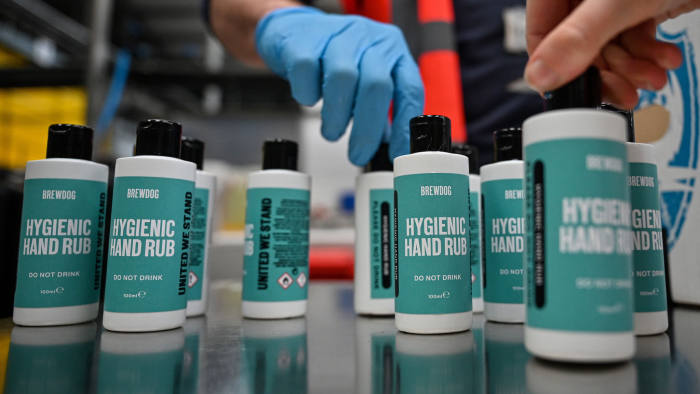 ELLON, SCOTLAND - APRIL 03: Workers at BrewDog brewery pack hands sanitiser being produced at the plant on April 03, 2020 in Ellon, Scotland. Scotland based brewery BrewDog have adapted their production to develop and produce hand sanitiser to donate to various charities across the UK as well as the NHS working throughout the Coronavirus (COVID-19) pandemic. The Coronavirus (COVID-19) has spread to many countries across the world, claiming over 50,000 lives and infecting over 1 million people. (Photo by Jeff J Mitchell/Getty Images)