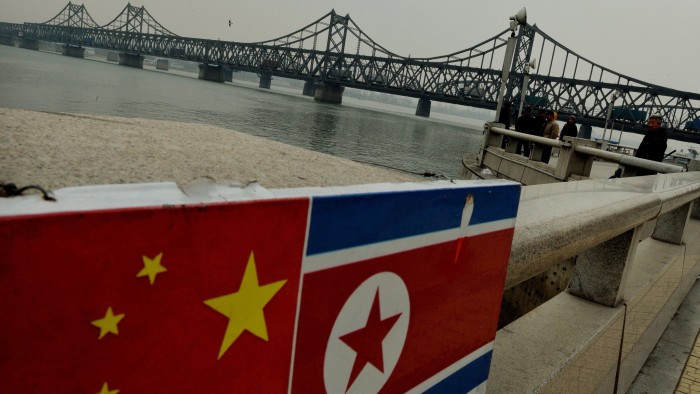 The Chinese and North Korean flags attached to a railing as trucks carrying Chinese-made goods cross into North Korea on the Sino-Korean Friendship Bridge at the Chinese border town of Dandong on December 18, 2013. China has lost its key North Korean interlocutor with the purging of Kim Jong-Un's uncle, but analysts say the young leader's tightening grip on power may be welcomed by Beijing, which prizes stability in its wayward nuclear-armed ally. Jang Song-Thaek was the second-most powerful member of North Korea's regime and an important link between Pyongyang and Beijing before his dramatic ouster last week, accused of being a corrupt, drug-using womaniser. AFP PHOTO/Mark RALSTON (Photo credit should read MARK RALSTON/AFP/Getty Images)