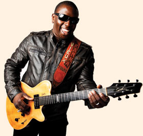 Vieux Farka Touré playing a guitar