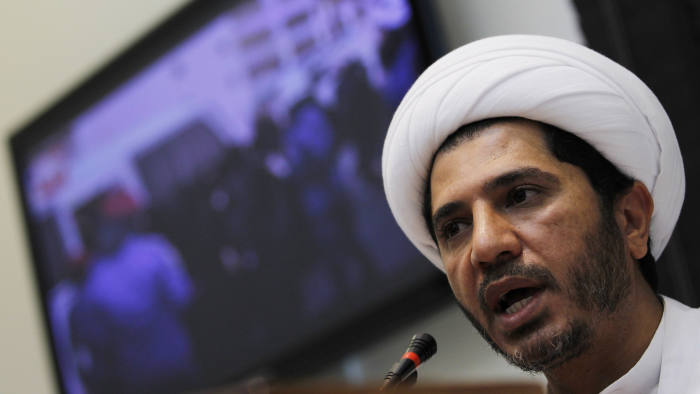Salman, head of Shi'ite opposition party Al Wefaq, speaks during a news conference in Manama...Sheikh Ali Salman, head of Shi'ite opposition party Al Wefaq, speaks during a news conference, as a television set in the background shows pictures of Bahraini women riot police arresting female protesters, in Manama September 25, 2011. Al-Wafaq boycotted by-elections on Saturday, held to fill 18 seats in the lower house of its parliament, which were vacated by Al Wefaq members earlier this year during a crackdown. REUTERS/Hamad I Mohammed (BAHRAIN - Tags: ELECTIONS POLITICS CIVIL UNREST)