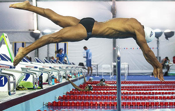 Olympic refugee team swimmer Rami Anis dives while training at the Olympic Aquatics Stadium