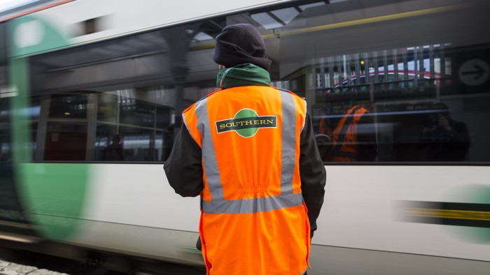 LONDON, ENGLAND - OCTOBER 18: A Southern rail conductor looks on as a Southern rail train leaves East Croydon station on October 18, 2016 in London, England. Staff at Southern rail have begun a second three-day strike over plans for drivers, instead of conductors, to operate train doors. The action will see hundreds of trains cancelled and other services affected as a result. (Photo by Jack Taylor/Getty Images)