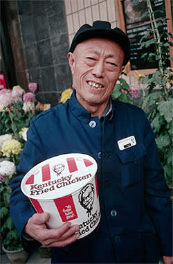 ca. 1980s, Beijing, China --- KFC Restaurant Worker in Tiananmen Square 