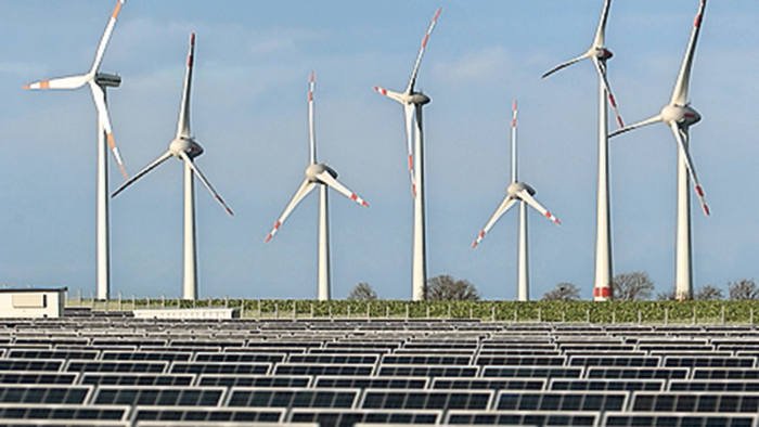 Wind turbines stand behind a solar power park on October 30, 2013 near Werder, German