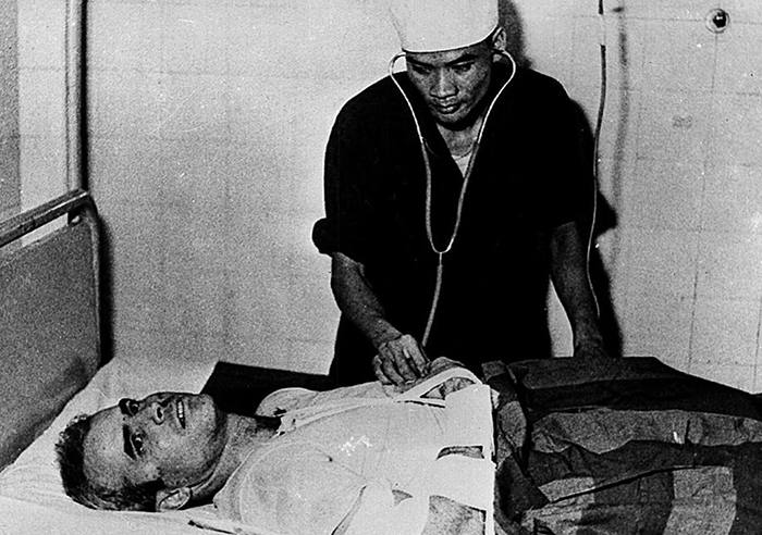 A photo taken in 1967 shows US Navy Airforce Major...HANOI, VIET NAM: A photo taken in 1967 shows US Navy Airforce Major John McCain being examined by a Vietnamese doctor. John McCain, current US presidential hopeful, was captured in 1967 at a lake in Hanoi after his Navy warplane was been downed by Northern Vietnamese army during the Vietnam War. One of his rescuers said 24 February 2000, McCain was well treated after being pulled from the lake by villagers. McCain said that upon capture he was beaten by an angry mob and bayoneted in the groin. (B/W ONLY) AFP PHOTO (Photo credit should read AFP/Getty Images)