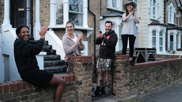 LONDON, UNITED KINGDOM - APRIL 23: Flat mates show their support outside their home on April 23, 2020 in London, United Kingdom. Following the success of the "Clap for Our Carers" campaign, members of the public are being encouraged to applaud NHS staff and other key workers from their homes at 8pm every Thursday. The Coronavirus (COVID-19) pandemic has infected over 2.5 million people across the world, claiming at least 18,738 lives in the U.K. (Photo by Julian Finney/Getty Images)