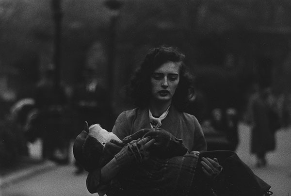 Woman carrying a child in Central Park, NYC, 1956