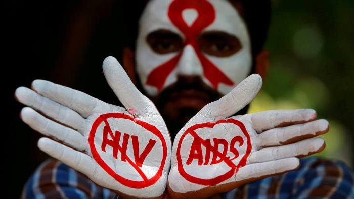 FILE PHOTO: A student displays his hands painted with messages as he poses during an HIV/AIDS awareness campaign to mark the International AIDS Candlelight Memorial, in Chandigarh, India, May 20, 2018. REUTERS/Ajay Verma/File Photo