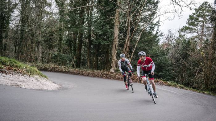 Tom Robbins puts the bicycle through its paces with a colleague on Box Hill, UK. December 14 2015. Tom Jamieson for The FT Weekend