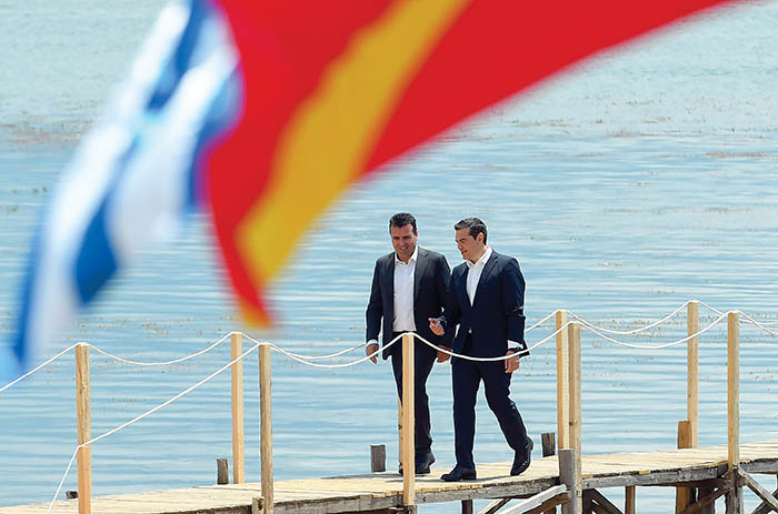 Macedonian Prime Minister Zoran Zaev (L) welcomes Greek Prime Minister Alexis Tsipras on the shore of the Lake Prespa near Otesevo on June 17, 2018. - The foreign ministers of Greece and Macedonia signed a historic preliminary accord to end a 27-year bilateral row by renaming Macedonia to Republic of North Macedonia. (Photo by Maja ZLATEVSKA / AFP) / ALTERNATIVE CROP (Photo credit should read MAJA ZLATEVSKA/AFP/Getty Images)