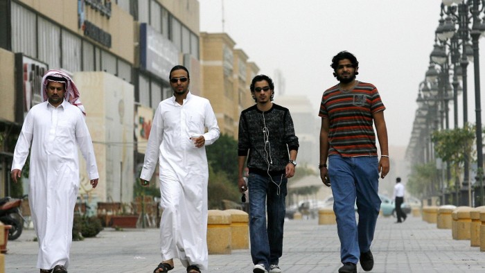 Saudi youths walk together in a business district in the Saudi capital Riyadh on February 18, 2009. Saudis have cheered King Abdullah's sweeping government shakeup as a bold step forward, after he sacked two powerful conservative religious figures and named the country's first-ever woman minister. The Saudi monarch announced the first major government shakeup on February 14 since he became king in August 2005, naming four new ministers, changing a number of top judiciary chiefs and shaking up the Ulema Council, the leading clerics whose interpretations of Islamic rules underpin daily life in the kingdom. AFP PHOTO/STR (Photo credit should read -/AFP/Getty Images)