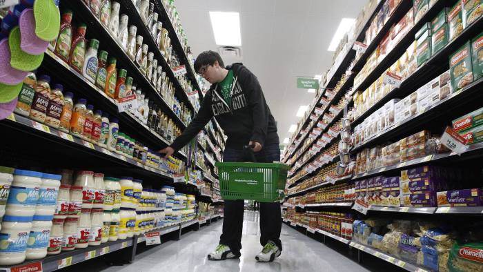 A shopper looks over items in an aisle at a newly opened Walmart Neighborhood Market in Chicago, September 21 2011. The 27,000 square foot (2508 square meters) store is the first in Illinois with an emphasis on groceries and basic household goods. REUTERS/Jim Young (UNITED STATES - Tags: FOOD BUSINESS)