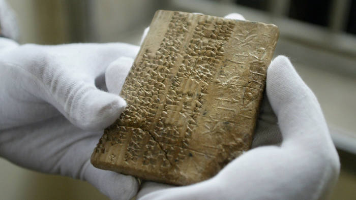 TO GO WITH ARABIC STORY IRAN-US-ARCHAEOLOGY: An Archaemenian clay tablet, in the Elamite scripts, which were written in cuneiform writing, is shown at Iran's National Museum in Tehran, 01 May 2004. An American delegation returned to Iran's National Museum a set of 300 ancient tablets held by the University of Chicago's Oriental Institute on loan to them since 1937. The tablets record the workings of the Persian administration -- including details such as the daily food rations given to workers -- but perhaps more importantly they provide one of the few Persian sources of information on the Persian Empire. Much of what is known about the empire -- which sprawled from Ethiopia to Egypt, Greece, modern-day Turkey, Central Asia and India -- has been gathered from Greek and Latin texts, according to the experts at the Oriental Institute. These tablets record the administrative details of the Persian Empire from about 500 BC. AFP PHOTO/Behrouz MEHRI (Photo credit should read BEHROUZ MEHRI/AFP via Getty Images)