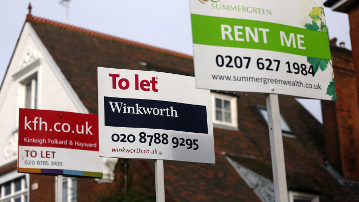 Estate agent signs advertising properties &quot;To Let&quot; and ''Rent Me&quot; stand outside residential buildings in the Roehampton district of London, U.K., on Friday, Nov. 23, 2012. U.K. mortgage approvals rose to a nine-month high in October, the British Bankers' Association said. Photographer: Simon Dawson/Bloomberg