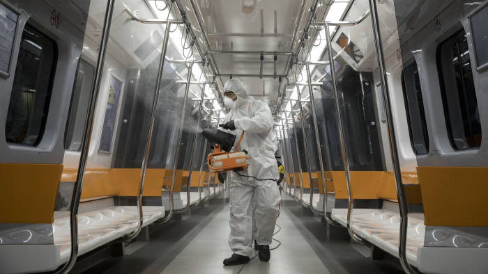 Metropolitan municipality worker sprays disinfectant over a metro train in Istanbul. The IMF said the pandemic did not look like a normal recession