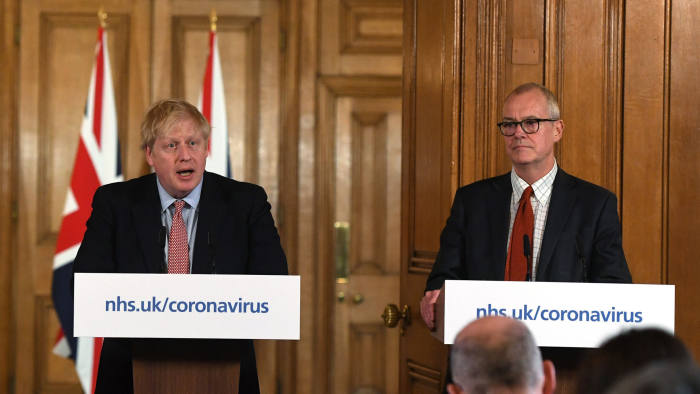 Boris Johnson, U.K. prime minister, center, speaks while Chris Whitty, U.K. chief medical officer, left, and Patrick Vallance, U.K. lead science adviser, listen during a coronavirus news conference inside number 10 Downing Street in London, U.K., on Thursday, March 12, 2020. Johnson said the true scale of the outbreak may be "much higher" than the 590 patients who have tested positive for the virus in the U.K. so far. Photographer: Facundo Arrizabalaga/EPA/Bloomberg