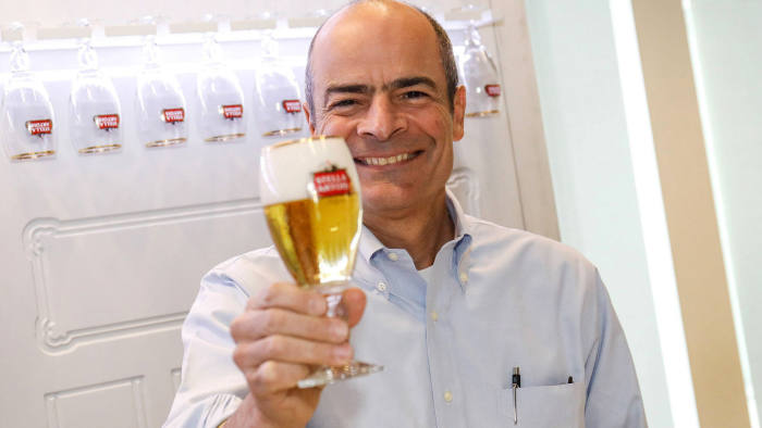 Carlos Brito, chief executive officer of Anheuser-Busch InBev NV, poses for a photograph while holding a goblet glass of Stella Artois lager beer as the brewing company announces full year earnings in Leuven, Belgium, on Thursday, March 1, 2018. The brewer of Budweiser has trounced most major producers of consumer goods in sales growth, fueled by exports of Stella Artois and Corona. Photographer: Dario Pignatelli/Bloomberg