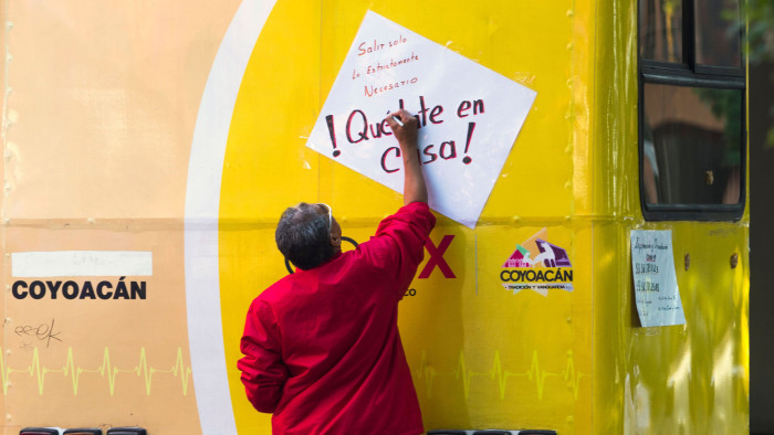 A worker of the Health Service writes a sign reading: &quot;Leave only when strictly necessary. Stay home&quot;, in Mexico City, on March 29, 2020, following the government decision to suspend all non-essential activities to help stem the spread of the coronavirus COVID-19. - Mexico was entering this week on phase two of its coronavirus approach, moving from containment to 'mitigation'. (Photo by CLAUDIO CRUZ / AFP) (Photo by CLAUDIO CRUZ/AFP via Getty Images)