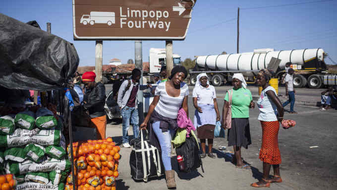 A women carries bags on July 28, 2018 towards the Beitbridge border post, near Musina, used by many Zimbabweans as a way to get back into Zimbabwe from South Africa so they can vote in the National elections. - The Beitbridge crosses over the Limpopo river which is an infamous crossing point for illegal migrants and refugees coming into South Africa from Zimbabwe. Many Zimbabweans are using this border post as a way to get back into Zimbabwe from South Africa so they can vote in the Zimbabwean National elections that take place on 30 July 2018. (Photo by WIKUS DE WET / AFP) (Photo credit should read WIKUS DE WET/AFP/Getty Images)