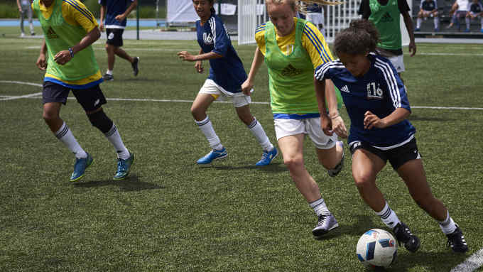 This photo taken on July 5, 2016 in Lyon shows budding football players playing during the "Streetfootballworld Festival 16", an international solidarity tournament that takes place for the first time during the duration of the UEFA Euro 2016 football championship. 
Some 450 girls and boys between 14 and 18 coming from 60 countries, the Brazilian favelas of Rio, shanty towns in India, South African townships and underprivileged European suburbs, meet thanks to "Streetfootballworld Festival 16" aiming at changing the world through football. / AFP / JEAN-PHILIPPE KSIAZEK        (Photo credit should read JEAN-PHILIPPE KSIAZEK/AFP/Getty Images)