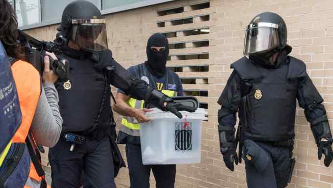 epa06238250 Spanish National Police officers seize a ballot box during a raid at a health clinic during the '1-O Referendum' in Cappont, Lleida, Catalonia, northeastern Spain, on 01 October 2017. National Police officers and Civil guards have been deployed to seize voting material and to prevent the people from entering to the polling centers and vote in the Catalan independence referendum, that has been banned by the Spanish Constitutional Court, what has provocked clashes between pro-independence people and the police forces in some polling centers. EPA/Adria Ropero