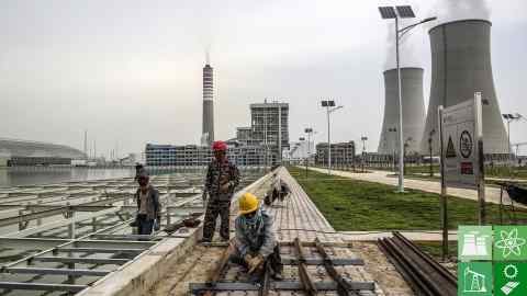 Workers labor at a construction site at the Sahiwal coal power plant, owned by China's state-owned Huaneng Shandong Rui Group, in Sahiwal, Punjab, Pakistan, on Wednesday, June 14, 2017. Pakistan is racing to bridge its power supply gap before national elections next year after a series of widespread blackouts highlighted the fragility of the network and its negative pull on South Asia’s second largest economy. Photographer: Asad Zaidi/Bloomberg