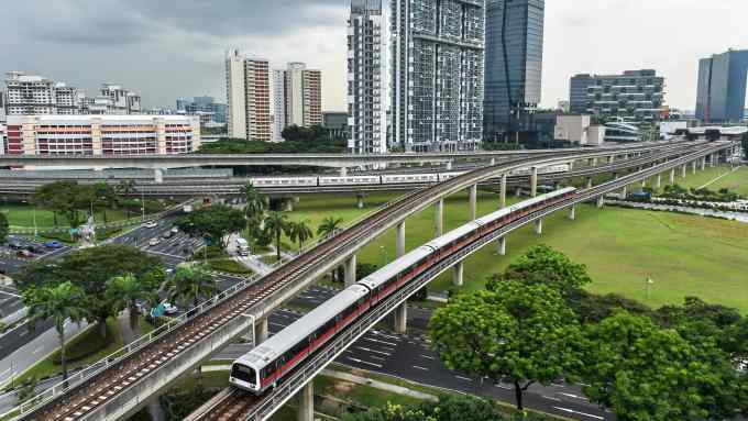 Singapore Mass Rapid Transit (SMRT) trains ply along lines at the Jurong East interchange (back R) in Singapore on July 18, 2016. / AFP / ROSLAN RAHMAN (Photo credit should read ROSLAN RAHMAN/AFP/Getty Images)