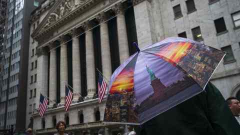 NEW YORK, NY - OCTOBER 11: A man holds a New York City-themed umbrella outside the New York Stock Exchange (NYSE) on a rainy day in the Financial District, October 11, 2018 in New York City. Following a massive sell-off of over 800 points on Wednesday, the Dow Jones Industrial Average fell over 100 points in Thursday morning trading. (Photo by Drew Angerer/Getty Images)
