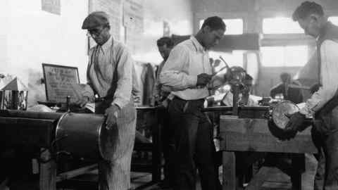 FILE - In this March 26, 1937, file photo, Works Progress Administration (WPA) workers make copper utensils for Pima County Hospital in Texas. The New Deal was a try-anything moment during the Great Depression that remade the role of the federal government in American life. (AP Photo, File)