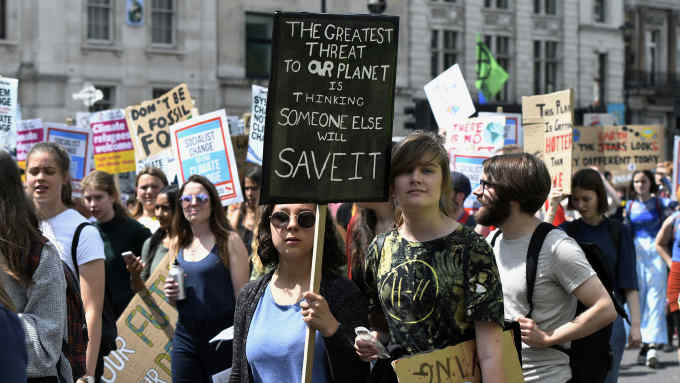 WHITEHALL, LONDON, GREATER LONDON, UNITED KINGDOM - 2019/06/21: Students hold placards at the Parliament Square during a March. Students gathered at Parliament Square and marched through central London demanding from the government and politicians direct actions to tackle the climate change. (Photo by Andres Pantoja/SOPA Images/LightRocket via Getty Images)