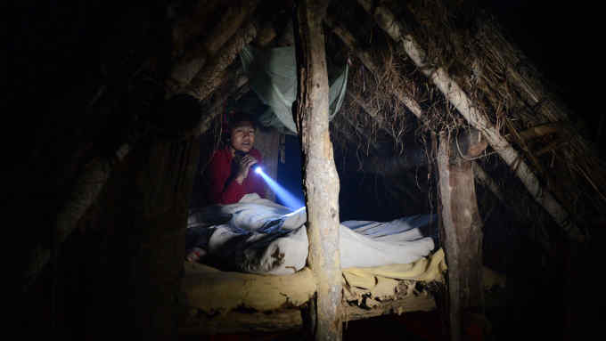 In this photograph taken on February 3, 2017, Nepalese woman Pabitra Giri prepares to sleep in a Chhaupadi hut during her menstruation period in Surkhet District, some 520km west of Kathmandu.