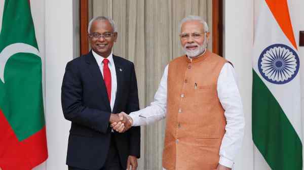 Maldivian President Ibrahim Mohamed Solih, left, and Indian Prime Minister Narendra Modi shake hands ahead of their meeting in New Delhi.