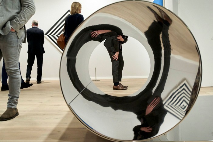 A silver bowl reflecting the photographer's distorted way