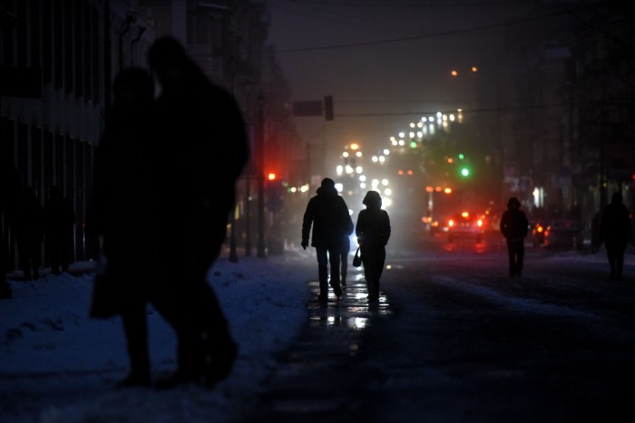 People walk in a street without electricity in Kyiv, Ukraine, on  December 8