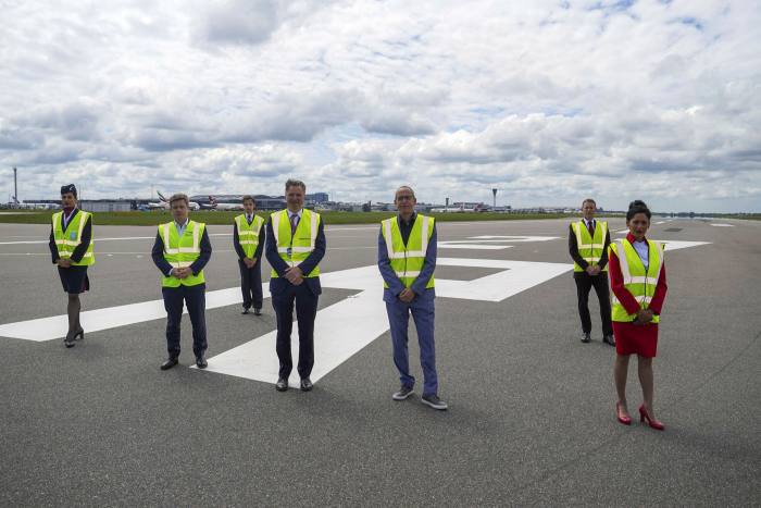 British Airways CEO Sean Doyle, John Holland-Kaye, CEO of Heathrow Airport and Virgin Atlantic CEO Shai Weiss, with fleets from British Airways and Virgin Atlantic on a closed runway