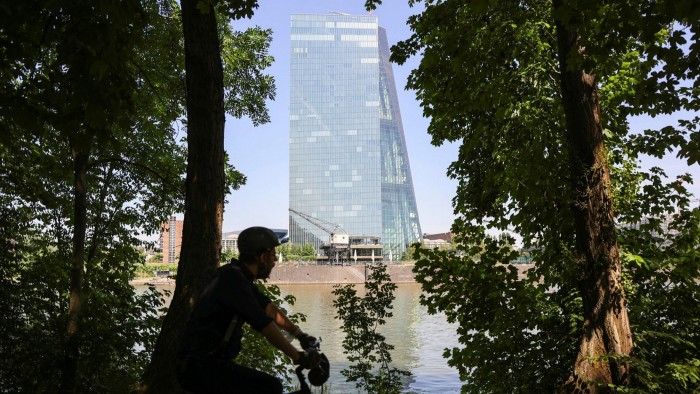 A cyclist rides past the European Central Bank headquarters 