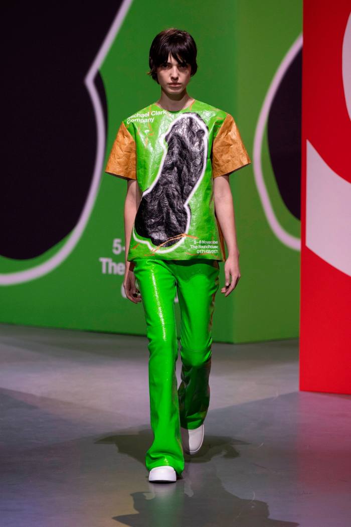 A male model in green trousers and patterned top