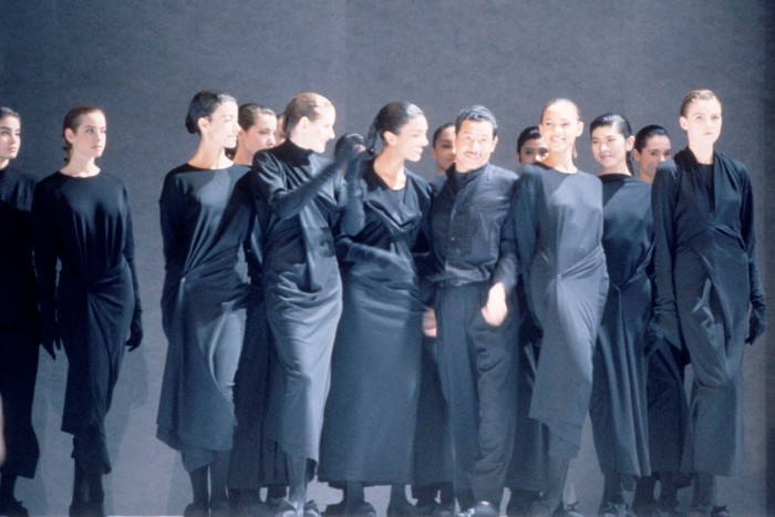 Models dresssed in long black dresses on the catwalk with Issey Miyake at a show in Tokyo in 1987