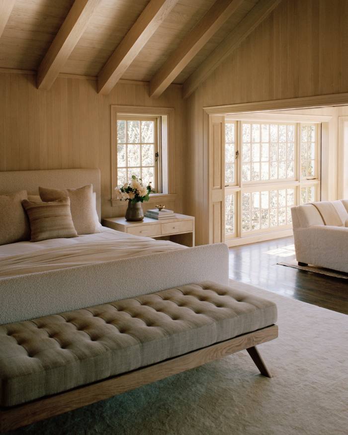 Blond-wood beams and a Classic Design custom bed made up with Frette linens in one of the bedrooms